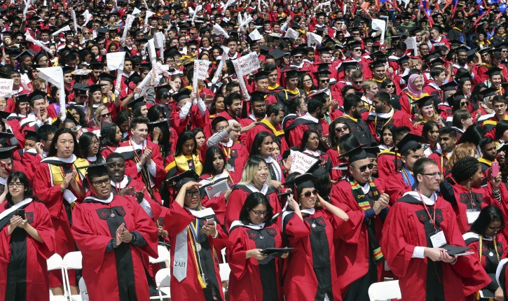 Rutgers University students cheer President Barack Obama during the Rutgers graduation ceremonies Sunday, May 15, 2016 in Piscataway, N.J. President Obama delivered a commencement address at Rutgers University. (AP Photo/Mel Evans)