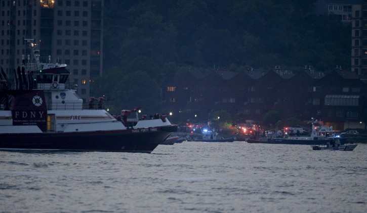 Search and rescue boats look for a small plane that went down in the Hudson River, Friday, May 27, 2016. (AP Photo/Julie Jacobson)