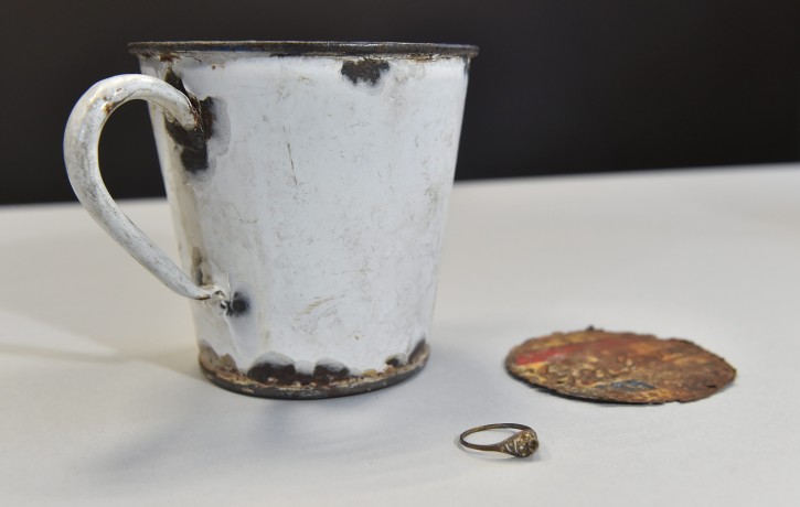  An enamel mug with a double bottom in which the jewellery was found is presented at a press conference at the Auschwitz-Birkenau State Museum in Oswiecim, Poland, 19 May 2016. Auschwitz Museum curators discovered the jewellery, a gold ring and necklace, during maintenance works on kitchenware items looted by German forces from the people who arrived at the Auschwitz-Birkenau camp during the World War II. The jewellery was hidden in a double bottom enamel mug and were discovered after the fake bottom deteriorated over time. the jewellery will be documented and secured in the Auschwitz-Birkenau State Museum.  EPA/JACEK BEDNARCZYK