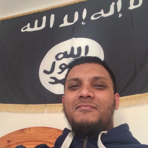 A photograph of Junead Khan smirking in front of an Islamic State-style black flag was found on his iPhone.