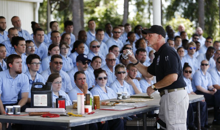 In this Tuesday, June 7, 2016, photo, Transportation Security Administration instructor Larry Colburn gives an explosives lecture to airport security officer candidates at the Federal Law Enforcement Training Center in Brunswick, Ga. Short-staffed and often criticized, the TSA aims to improve training for airport screeners. (AP Photo/John Bazemore)
