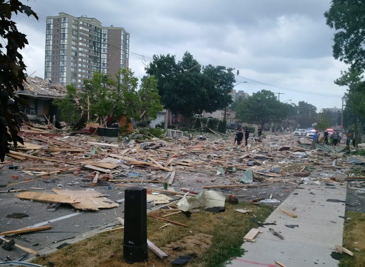 Debris litters a street after a house explosion in Mississauga, Ontario, Tuesday, June 28, 2016. Police are evacuating homes in the area as they investigate the explosion.  (Zeljko Zidaric/The Canadian Press via AP) 