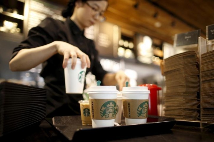 FILE - A staff serves beverages at a Starbucks coffee shop in Seoul, South Korea, in this March 7, 2016, file photo. REUTERS/Kim Hong-Ji/Files