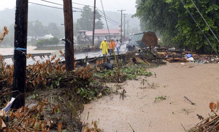 In this photo made from video, debris from the Jordan Creek near Clendenin, W.Va., piles up against a culvert along U.S. 119 on Thursday night June 23, 2016, just before the creekâs entry into the Elk River. Multiple fatalities have been reported in flooding that has devastated parts of the state, a state official said Friday morning. The fatalities included at least one child and one adult.(Chris Dorst/Gazette-Mail via AP)