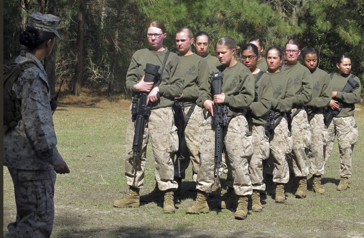 FILE - In this Feb. 21, 2013 file photo, female recruits stand at the Marine Corps Training Depot on Parris Island, S.C.  U.S. Secretary of the Navy Ray Mabus said in an interview on June 3, 2016, that the Navy and Marine Corps will be dropping âmanâ from some of their job titles to make them inclusive and gender-neutral. (AP Photo/Bruce Smith, File)