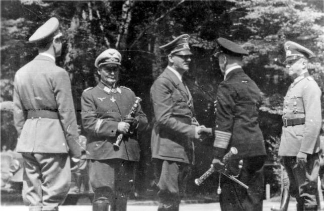 A historical photograph shows an unidentified officer, Hermann Goering, Adolf Hitler, Erich Raeder and Wilhelm Keitel (from L-R) standing in the French village of Compiegne during World War II June 22, 1940. REUTERS/Patrick Kovacs