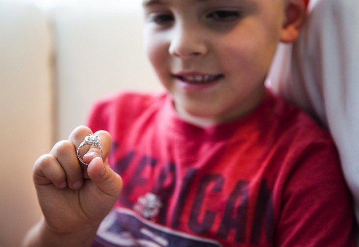 Landon Cornish, 4, on Friday holds up his mom’s ring, which he had flushed down the toilet a month ago at his family’s home in Bothell. After a plumber told the family that recovering the ring would be impossible, Anna Cornish’s husband, Ryan, asked for help from some Bothell city workers, who did come up with it. (Lindsey Wasson/The Seattle Times/AP)