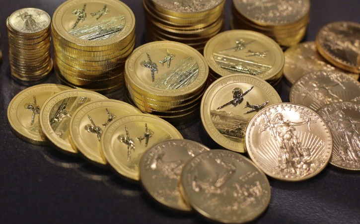 In this July 1, 2016, photo, gold coins lie on display at the office of Philip Diehl in Austin, Texas. Safety is a big draw since the shocking British vote to leave the European Union, sending gold prices soaring. (AP Photo/Eric Gay)