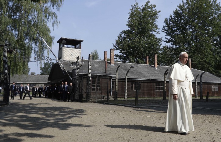 Pope Francis walks through the gate of the former Nazi German death camp of Auschwitz in Oswiecim, Poland, Friday, July 29, 2016. AP