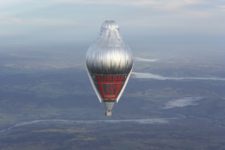In this July 12, 2016 Hand Out photo supplied by MORTON, Russian adventurer Fedor Konyukhov floats  at more than 6,000meters (20,000  feet) above Northern Western Australia, in his helium and hot-air balloon as he makes a record attempt to fly solo in a balloon around the world nonstop.  65-year-old Konyukhov was battling sleep deprivation, freezing temperatures and ice in his oxygen mask as he nears the end of his record attempt to fly solo around the world nonstop, his son said on Wednesday July 20, 2016.(Photo/Oscar Konyukhov/Morton Via AP)