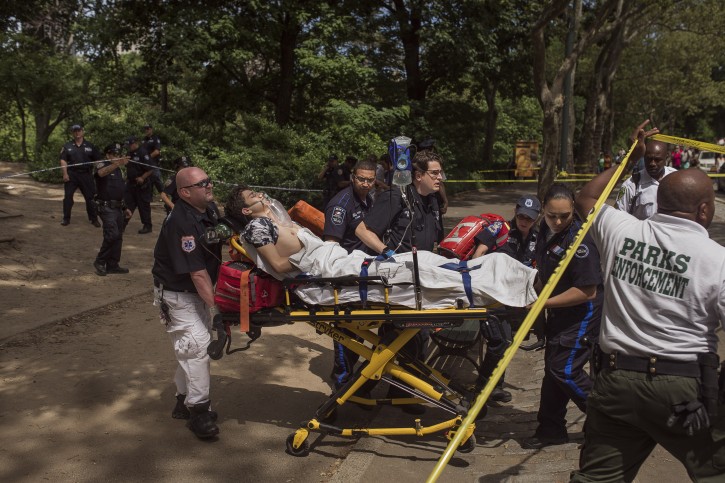 A injured man is carried to an ambulance in Central Park in New York, Sunday, July 3, 2016. Authorities say a man was seriously hurt in Central Park and people near the area reported hearing some kind of explosion. Fire officials say it happened shortly before 11 a.m., inside the park at 68th Street and Fifth Avenue. (AP Photo/Andres Kudacki)