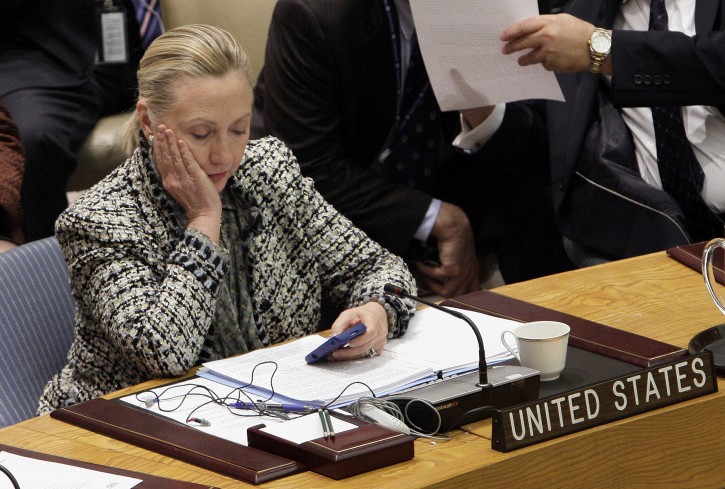 FILE - In this March 12, 2012 file photo, then-Secretary of State Hillary Rodham Clinton checks her mobile phone after her address to the Security Council at United Nations headquarters.  (AP Photo/Richard Drew, File)