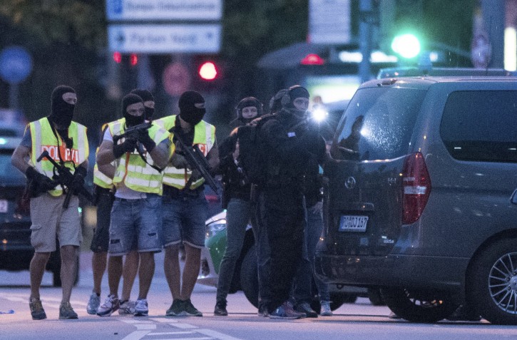 Special police forces prepare to search a neighboring shopping center outside the Olympia mall in Munich, southern Germany, Friday, July 22, 2016 after several people were killed in a shooting. (AP Photo/Sebastian Widmann)
