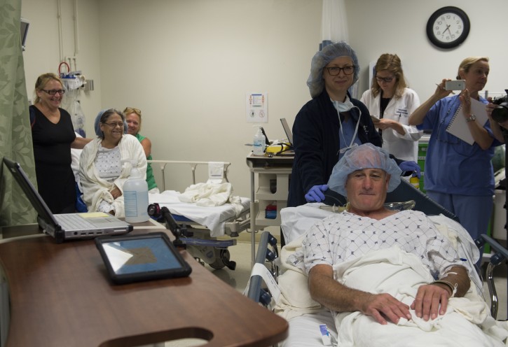 In this photo taken June 28, 2016, Brenda Hudson watches as her husband and kidney donor Dana, right, is taken to the operating room to undergo a living donor kidney transplant at MedStar Georgetown University Hospital in Washington. Hudson received a donated kidney from her sister Michelle 40 years ago, after lupus destroyed her own kidney's function. More than 120,000 people are on the nation's waiting list for an organ transplant, most of them for kidneys, and thousands die before receiving one because of a dire shortage of donors. (AP Photo/Molly Riley)