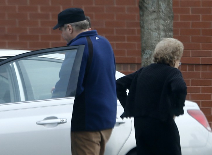 In this photo taken March 19, 2015, John Hinckley gets into his mother's car in front of a recreation center  in Williamsburg, Va. The last man to shoot an American president now spends most of the year in a house overlooking the 13th hole of a golf course in a gated community. He takes long walks along tree-lined paths, plays guitar and paints, grabs fast food at Wendyâs. He drives around town in a silver Toyota Avalon, a car that wouldnât attract a second glance. Often, as if to avoid detection, he puts on a hat or visor before going out. These days, John Hinckley Jr. lives much of the year like any average Joe: shopping, eating out, watching movies at Regal Cinemas. (AP Photo/ Steve Helber)