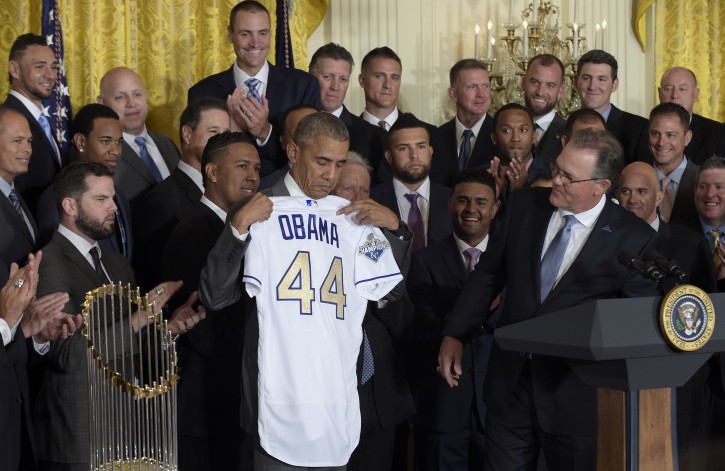 President Barack Obama holds up a personalized Kansas City Royals baseball jersey presented to him by team manager Ned Yost, right, during a ceremony in the East Room of the White House in Washington, Thursday, July 21, 2016, where the president honored the 2015 World Series Champion baseball team. (AP Photo/Susan Walsh)
