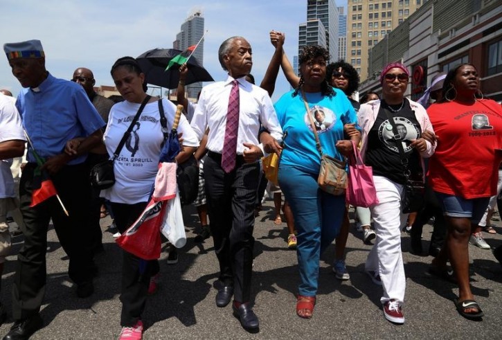 Rev. Al Sharpton (C) and mother of police chokehold victim Eric Garner, Gwen Carr (3rd R) lead a march two years after his death in the Brooklyn borough of New York, U.S., July 16, 2016. REUTERS/Bria Webb 