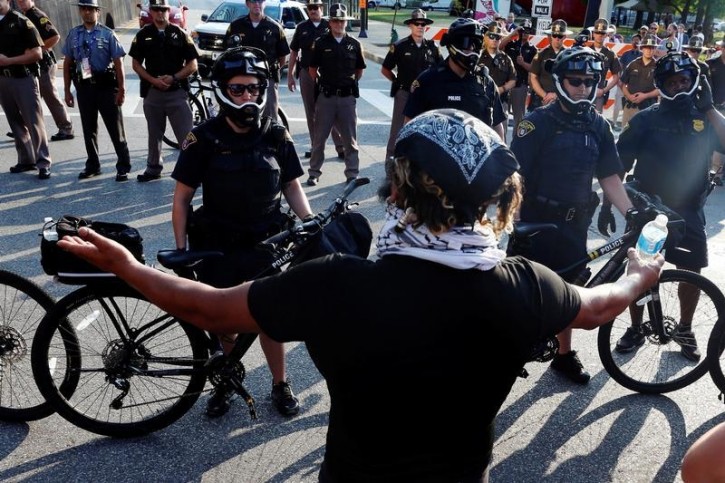 A protester confronts Cleveland Police officers during demonstrations near the Republican National Convention in Cleveland, Ohio, U.S., July 19, 2016.  REUTERS/Lucas Jackson  