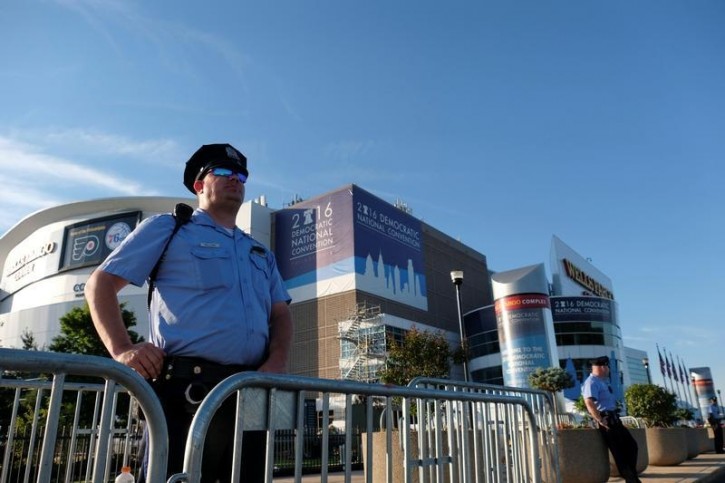 A police officer stands watch outside the Wells Fargo Center, site of the Democratic National Convention in Philadelphia, Pennsylvania, U.S., July 24, 2016. REUTERS/Bryan Woolston