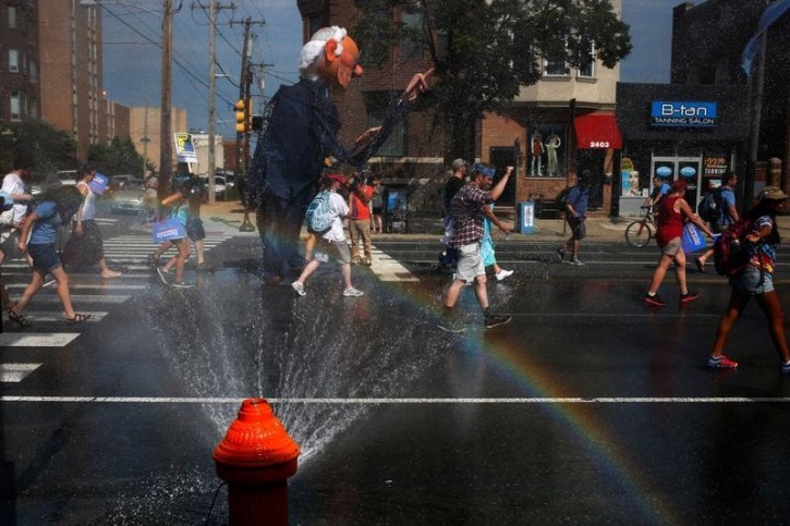 Supporters of U.S. Senator Bernie Sanders carry an effigy with his image as they pass a water hydrant during a protest march ahead of the 2016 Democratic National Convention in Philadelphia, Pennsylvania on July 24, 2016. REUTERS/Adrees Latif -