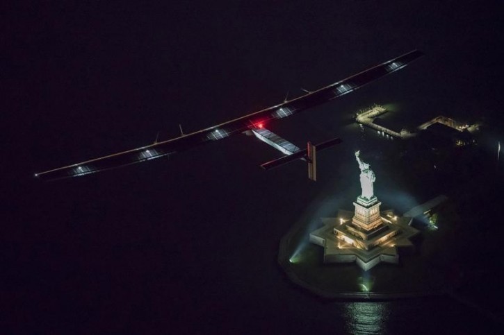 FILE - Solar Impulse 2, the solar airplane, piloted by Swiss adventurer Andre Borschberg, flies over the Statue of Libery in in New York, U.S., June 11, 2016 shortly before landing at John F. Kennedy airport. REUTERS