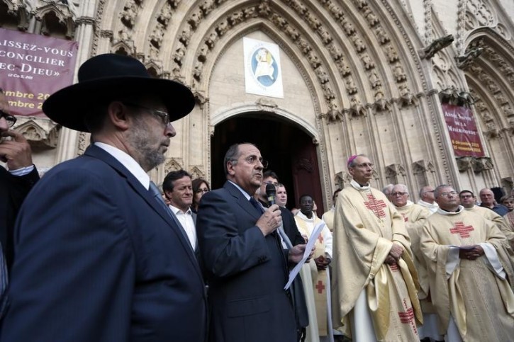 Michel Delpuech, French Prefect of the Auvergne Rhone-Alpes region speaks outside the Cathedral of Lyon, France, to pay tribute to French priest, Father Jacques Hamel, who was killed with a knife in an attack on a church in Saint-Etienne-du-Rouvray, near Rouen, that was carried out by assailants linked to Islamic State, July 26, 2016.   REUTERS/Robert Pratta 
