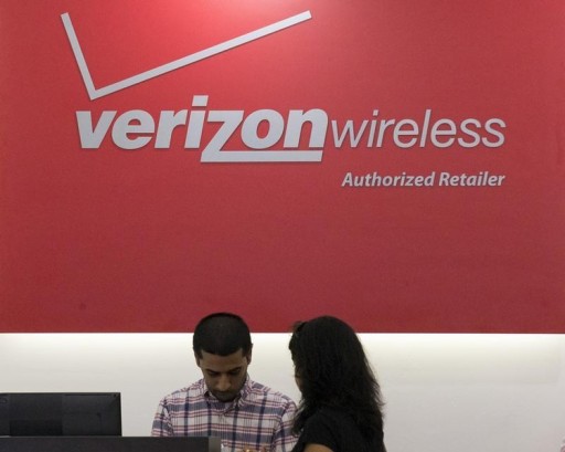 FILE -A woman is cashed out at a Verizon store in New York's financial district May 12, 2015. Reuters