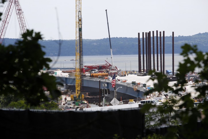 A construction crane sprawls across lanes in both directions after collapsing on the Tappan Zee Bridge, Tuesday July 19, 2016, in New York.  (AP Photo/The Journal News, Ricky Flores)