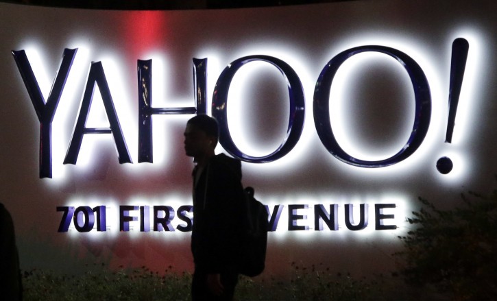FILE - In this Nov. 5, 2014, file photo, a person walks in front of a Yahoo sign at the company's headquarters in Sunnyvale, Calif. Yahoo reported Tuesday, April 19, 2016, that after subtracting ad commissions, Yahoo's revenue fell 18 percent from the same time a year earlier, to $859 million. It's the largest decline in Yahoo's quarterly net revenue since the company hired Marissa Mayer as its CEO nearly four years ago. (AP Photo/Marcio Jose Sanchez, File)