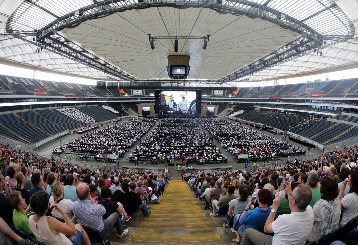 Spectators on the ranks of the Commerzbank Arena stadium watch members of a mass orchestra rehearsing for a World Record attempt on the pitch of the stadium in Frankfurt, Germany, 09 July 2016. An orchestra with more than 7,000 musicians from all over Germany gathers here for the initiative 'Wir fuellen das Stadium' (lit.: We fill the stadium) in an attempt to form the world biggest orchestra for an entry into the famous Guinness Book of Records. EPA/HASAN BRATIC
