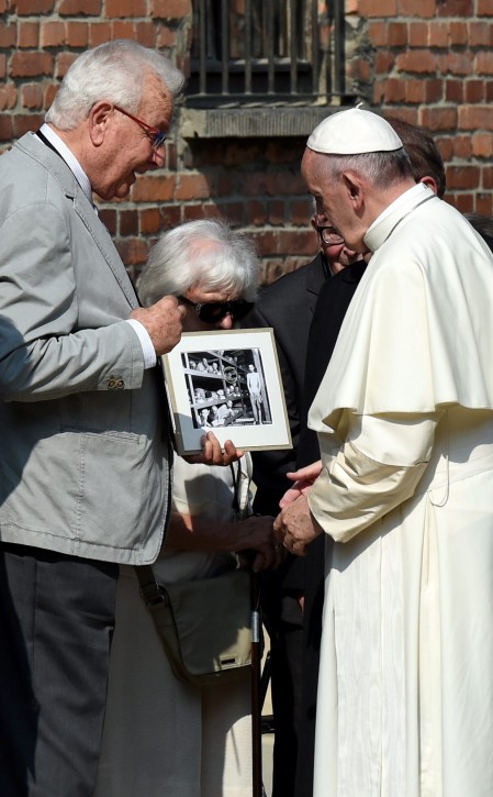  Former   Auschwitz concentration camp prisoner Naftali Fuerst (L) shows his camp picture to Pope Francis (R) in a yard next to the Death Wall in the former Nazi German concentration camp KL Auschwitz I in Oswiecim, Poland, 29 July 2016.  EPA