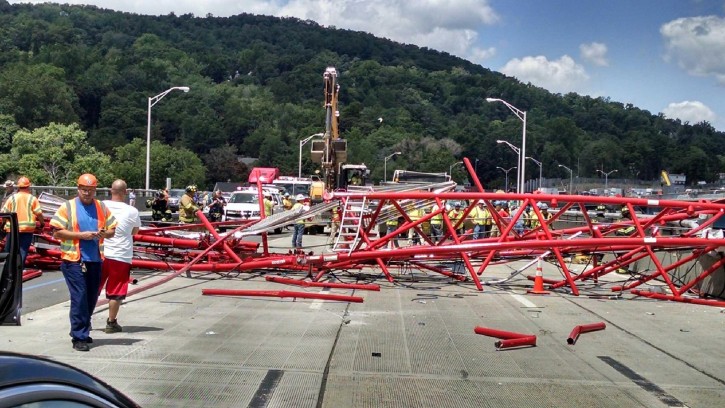 FILE - A giant crane sits on the Tappan Zee Bridge north of New York City after toppling around noon on Tuesday July 19, 2016, during construction of a new bridge, across the Hudson River between Westchester and Rockland counties.  AP