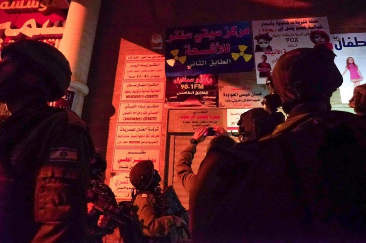 IDF soldiers stand outside the al-Sabanel radio station in Dura before closing the broadcaster because of ‘inciting programs’ on August 31, 2016. (IDF)