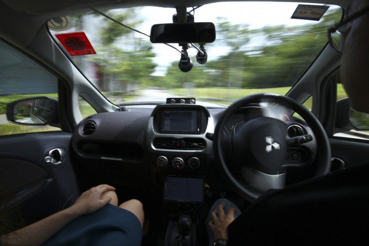 An autonomous vehicle undergoes a test drive  with a safety driver, right, in Singapore Wednesday, August 24, 2016. nuTonomy is commencing a two-week autonomous taxi service trial in Singapore's One North district and are planning for a public launch in 2018. (AP Photo/Yong Teck Lim)