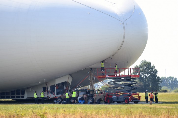 The Airlander 10, is examined as it sits on the ground after a rough landing  at Cardington airfield England  following its second test flight on Wednesday Aug. 24, 2016. The developer of the world's largest aircraft says the blimp-shaped airship 