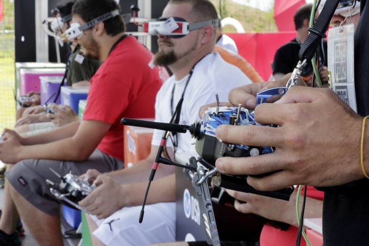 Pilots flew their small racing drones through an obstacle course on Governors Island, a former military installation in New York Harbor, Friday, Aug. 5, 2016. Drone pilots are gathering in New York City to compete in the National Drone Racing Championship. (AP Photo/Richard Drew)