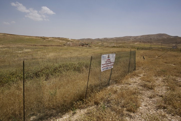 In this May 19, 2016 photo, the site where dozens of Yazidi men were killed in August, 2014 is fenced off in Hardan, northern Iraq. (AP Photo/Maya Alleruzzo)