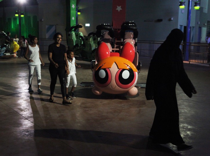 People get off the Powerpuff Girls - Mojo Jojo's Robot Rampage ride at the IMG Worlds of Adventure amusement park in Dubai, United Arab Emirates, on Wednesday, Aug. 31, 2016. The IMG Worlds of Adventure indoor theme park opened Wednesday in Dubai, hoping to draw thrill seekers to its air-conditioned confines. (AP Photo/Jon Gambrell)