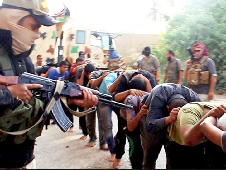 FILE -This image posted online by Islamic State militants on June 14, 2014 shows Iraqi cadets captured by IS moments before they were killed in Tikrit, Iraq. Iraqi officials say the country has executed 36 men on Sunday, Aug. 21, 2016 convicted of taking part in the Islamic State group's massacre of hundreds of soldiers in 2014.(militant photo via AP, File)