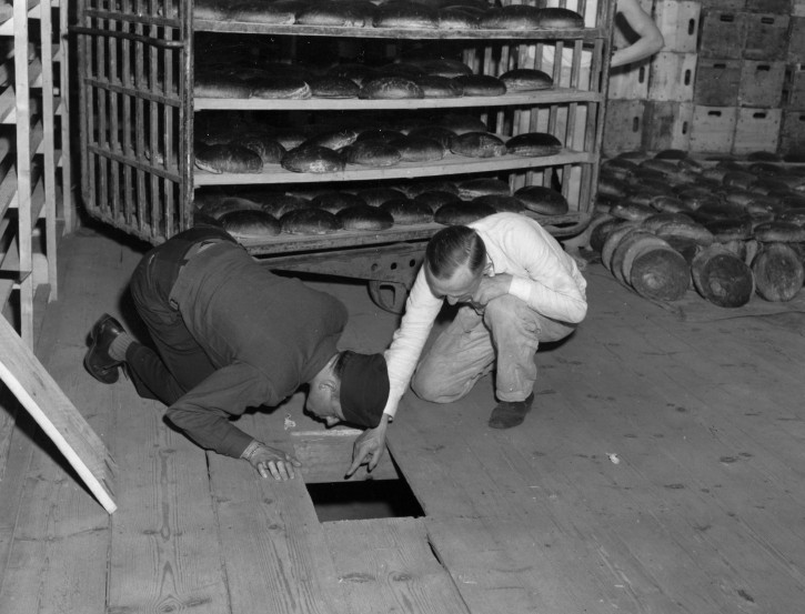 In this April 1946 photo from the U.S. Army Signal Corps, U.S. Lt. Robert R, Rogers, left, and Erich Pinkau, of the German criminal police, examine the under-floor hiding place where arsenic was found in a Nuremberg, Germany bakery which supplied bread to Stalag 13, seven miles away. In mid-April, over 2,200 prisoners at the camp were stricken with arsenic poisoning from the toxicant coated on the loaves given to the prisoners. Seventy years after the most daring attempt of Jewish Holocaust survivors to seek revenge, the leader of the plot has only one simple regret _ that to his knowledge he didn't actually succeed in killing any Nazis. Joseph Harmatz is one of the few remaining Jewish 