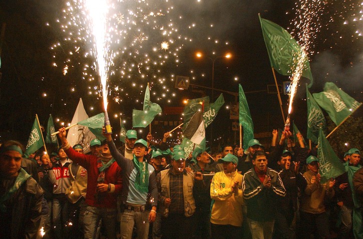 FILE -- In this Jan. 26, 2006 file photo, Palestinian supporters of Hamas celebrate their victory in parliamentary elections in the West Bank town of Hebron. Palestinian rivals Hamas and Fatah are gearing up for their first contest at the polls since 2006 -- a vote for 425 mayors and local councils in the West Bank and Gaza Strip on Sept. 8, 2016. Each side hopes the election will give it a foothold in what has been the other's exclusive territory since mutual purges in 2007. The ballot might not allow either side to proclaim victory, but will provide at least an indication of the popularity of Hamas and Fatah. (AP Photo/Nasser Shiyoukhi, File)