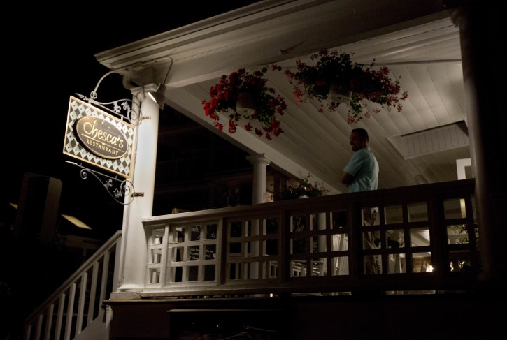 A Secret Service agent stands outside at the balcony of Chesca's Restaurant in downtown Edgartown, Mass., on Martha's Vineyard, Saturday, Aug. 20, 2016, where President Barack Obama and the first lady Michelle Obama are dining. (AP Photo/Manuel Balce Ceneta)