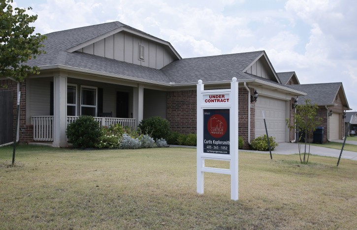 FILE - Real estate signs at a new home community are pictured in Edmond, Okla., Wednesday, July 27, 2016. (AP Photo/Sue Ogrocki)