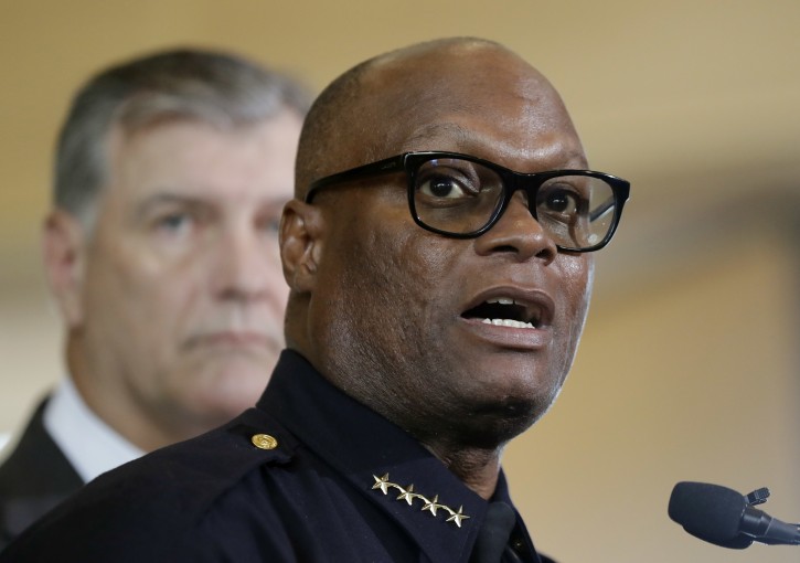 FILE - In this July 8, 2016, file photo, Dallas police chief David Brown, front, and Dallas mayor Mike Rawlings, rear, talk with the media during a news conference in Dallas. Nearly two months after the shootings, Dallas police have moved to silence critics and squelch lingering questions about the attack. Officers in riot gear have been told to ticket protesters who block or disrupt traffic, and Brown has refused to meet with demonstrators unless they agree to end their marches through downtown, which he said pose a threat to officers. (AP Photo/Eric Gay, File)