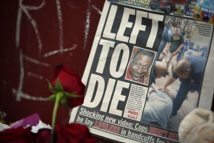 FILE - A picture of Eric Garner is seen on a newspaper at his memorial in Staten Island, New York, July 21, 2014. Reuters