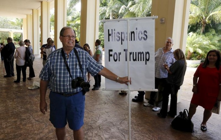 FILE - Ted Masters of Boynton Beach, Florida holds a sign before entering the ballroom for a rally by Republican presidential candidate Donald Trump at his Trump National Doral Miami resort in Doral, Florida, October 23, 2015. Reuters