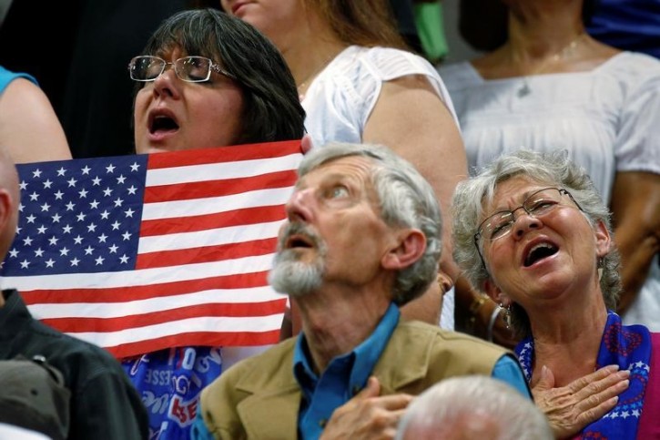 People sing the national anthem before Republican presidential nominee Donald Trump speaks at a campaign rally in Colorado Springs, Colorado, U.S., July 29, 2016. REUTERS/Carlo Allegri -