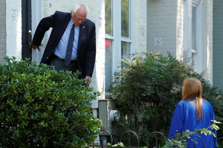 FILE - Democratic U.S. presidential candidate Bernie Sanders departs his house to walk with his wife Jane Sanders (R) to his campaign headquarters on Capitol Hill in Washington, U.S. June 20, 2016.  REUTERS/Jonathan Ernst -