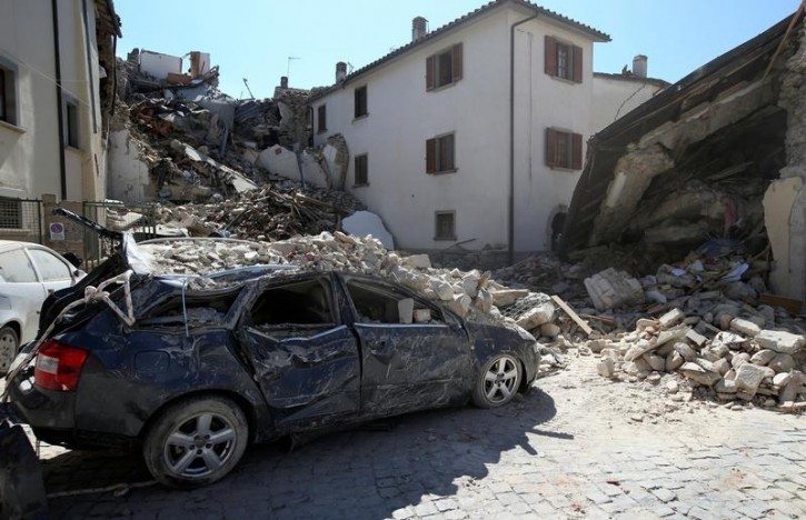A destroyed car is seen following an earthquake in Amatrice, central Italy, August 24, 2016. REUTERS/Stefano Rellandini 