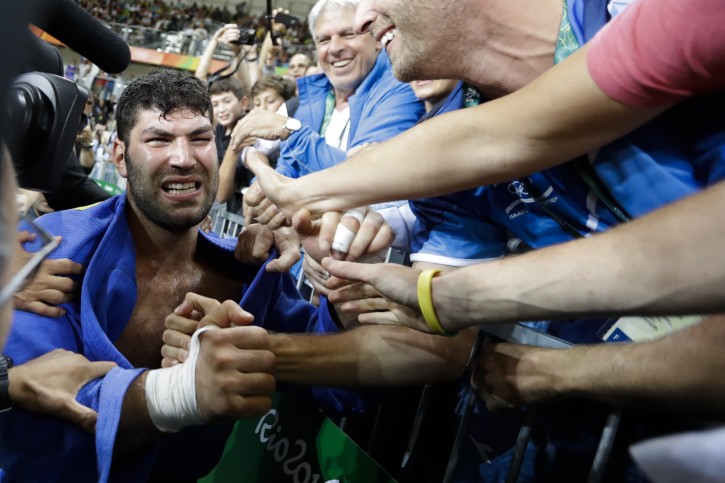 Israel's Or Sasson celebrates with supporters after winning the bronze medal during the men's over 100-kg judo competition at the 2016 Summer Olympics in Rio de Janeiro, Brazil, Friday, Aug. 12, 2016. (AP Photo/Markus Schreiber)